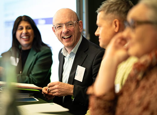 Law Society Council members smiling at a panel event.
