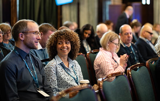 Solicitors sit in the audience at a Law Society conference.