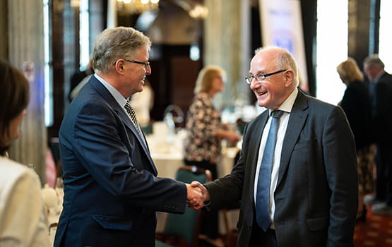Solicitors shaking hands at a Law Society event.