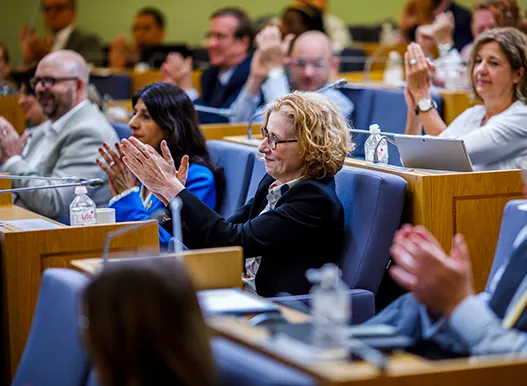 Law Society Council members applauding at a Council meeting.