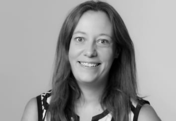 Alex Wilson is a white woman with shoulder-length hair. She is smiling widely.