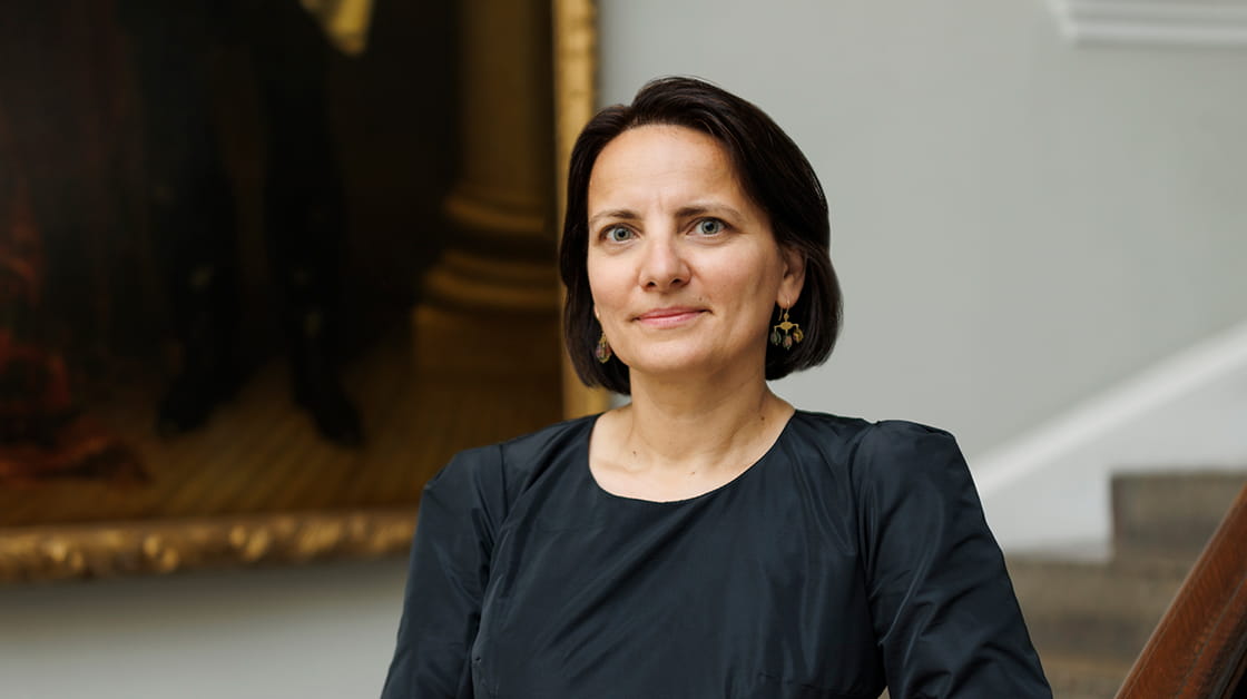 Dana Denis-Smith OBE stands on the library staircase at the Law Society’s Hall, London.
