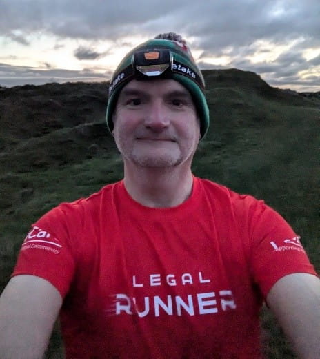 Mark Evans takes a selfie whilst out running in the countryside. He is wearing his red Legal Runner t-shirt.