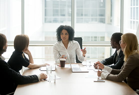 Group of colleagues sat around a table