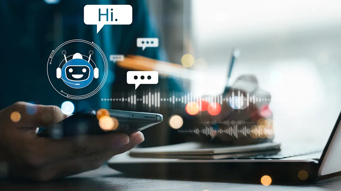 A designed image of a person working on a laptop, with images representing a chatbot in the foreground.