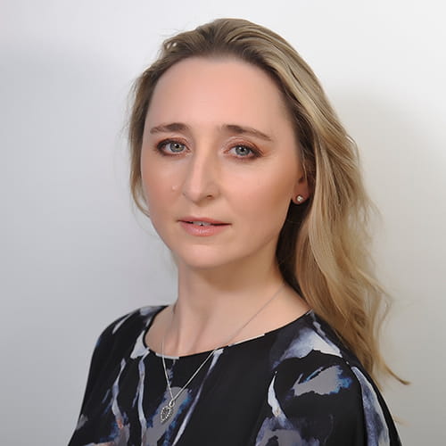 Amanda Gill wearing a dark patterned blouse