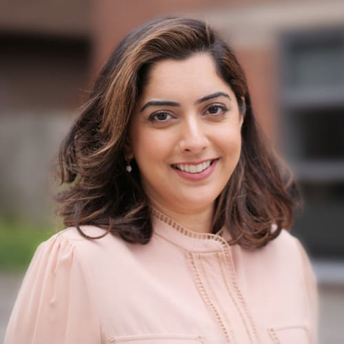 Amandeep Khasriya smiles wearing a light pink blouse.