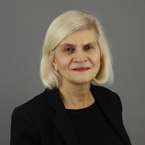 Josephine Duchenne smiles, wearing a black suit.