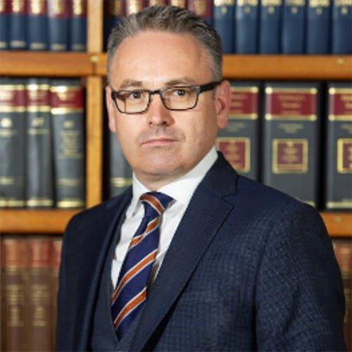 Mark Davies wearing a navy suit.