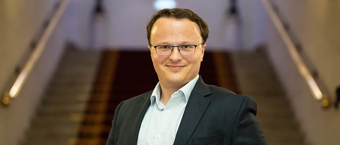 Legal Hero Martin Whitehorn stands holding his trophy.