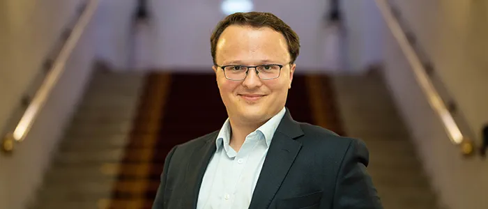 Legal Hero Martin Whitehorn stands holding his trophy.