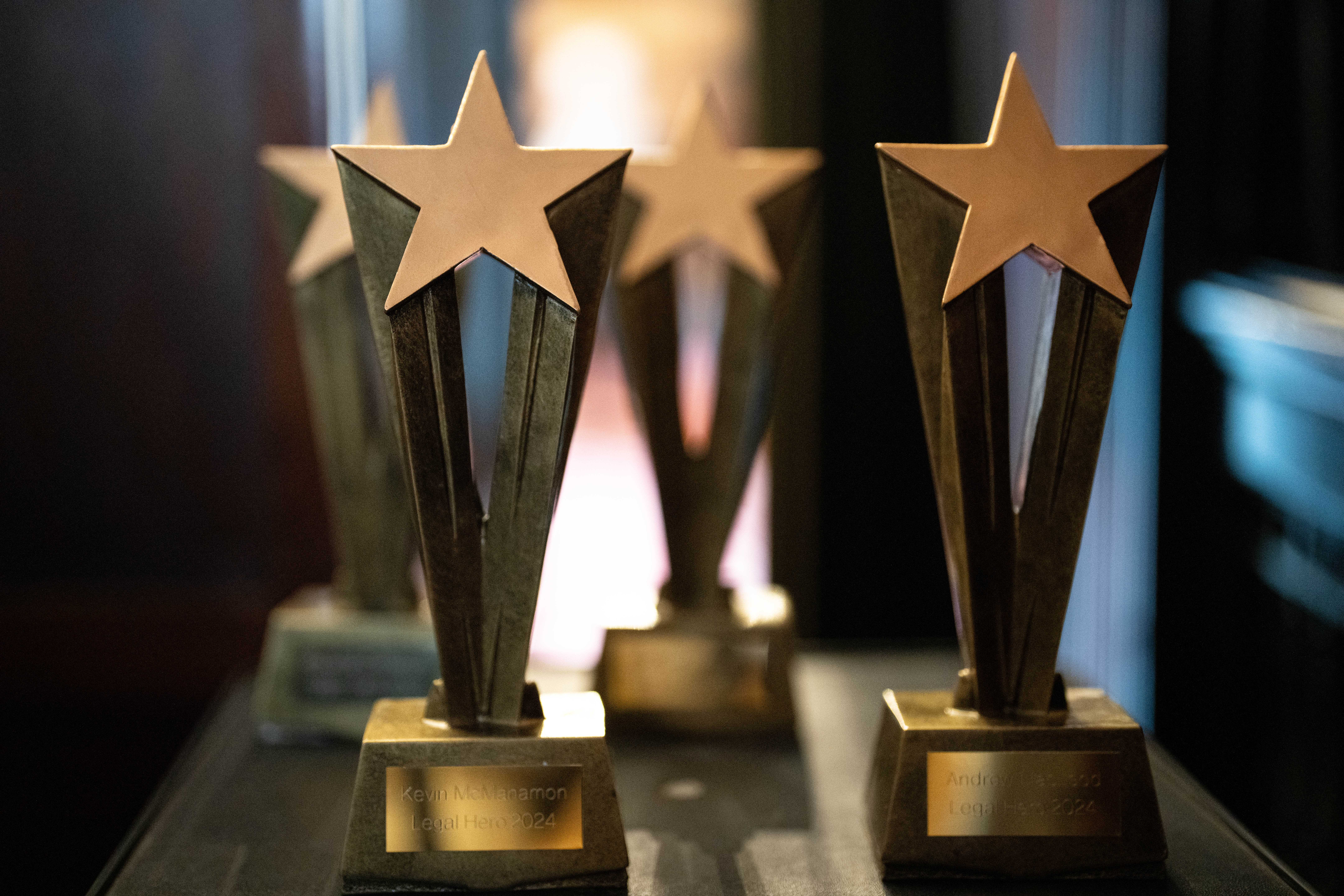 Four Legal Heroes trophies with stars on top.