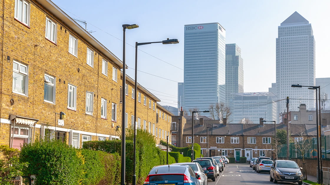 English terrace houses in contrast to Canary Wharf, a major financial district, in the background