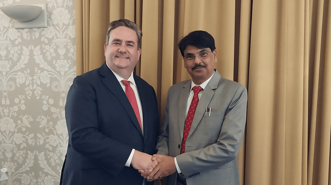 Our president Nick Emmerson is wearing a navy blue suit and red spotty tie. He is shaking hands with the BCI chairman Manan Kumar Mishra who is wearing a grey suit and red spotted tie. 