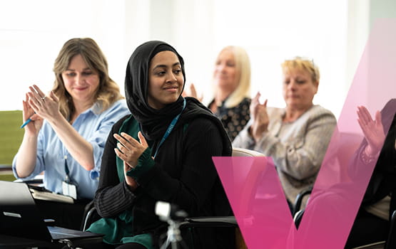 Solicitors applauding at an event.