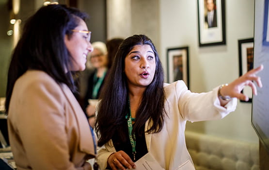 Two people talking at Law Society Risk and Compliance Conference.