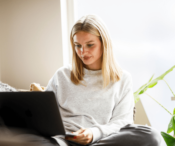 Young woman sitting behind laptop in informal work setting