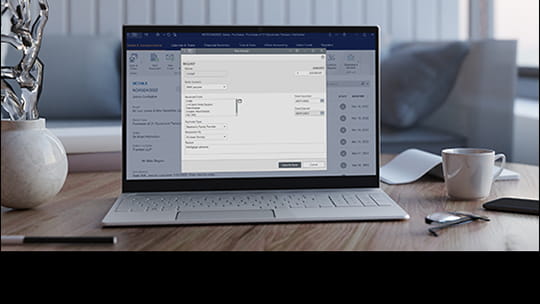 Laptop open on table with neutral home background