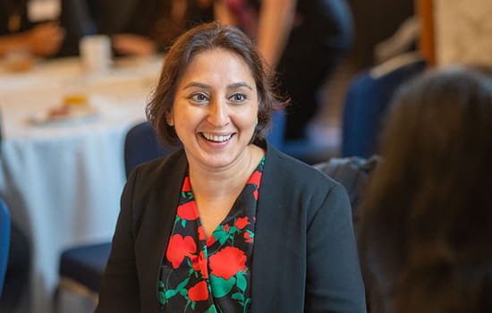 Image of woman smiling while in conversation