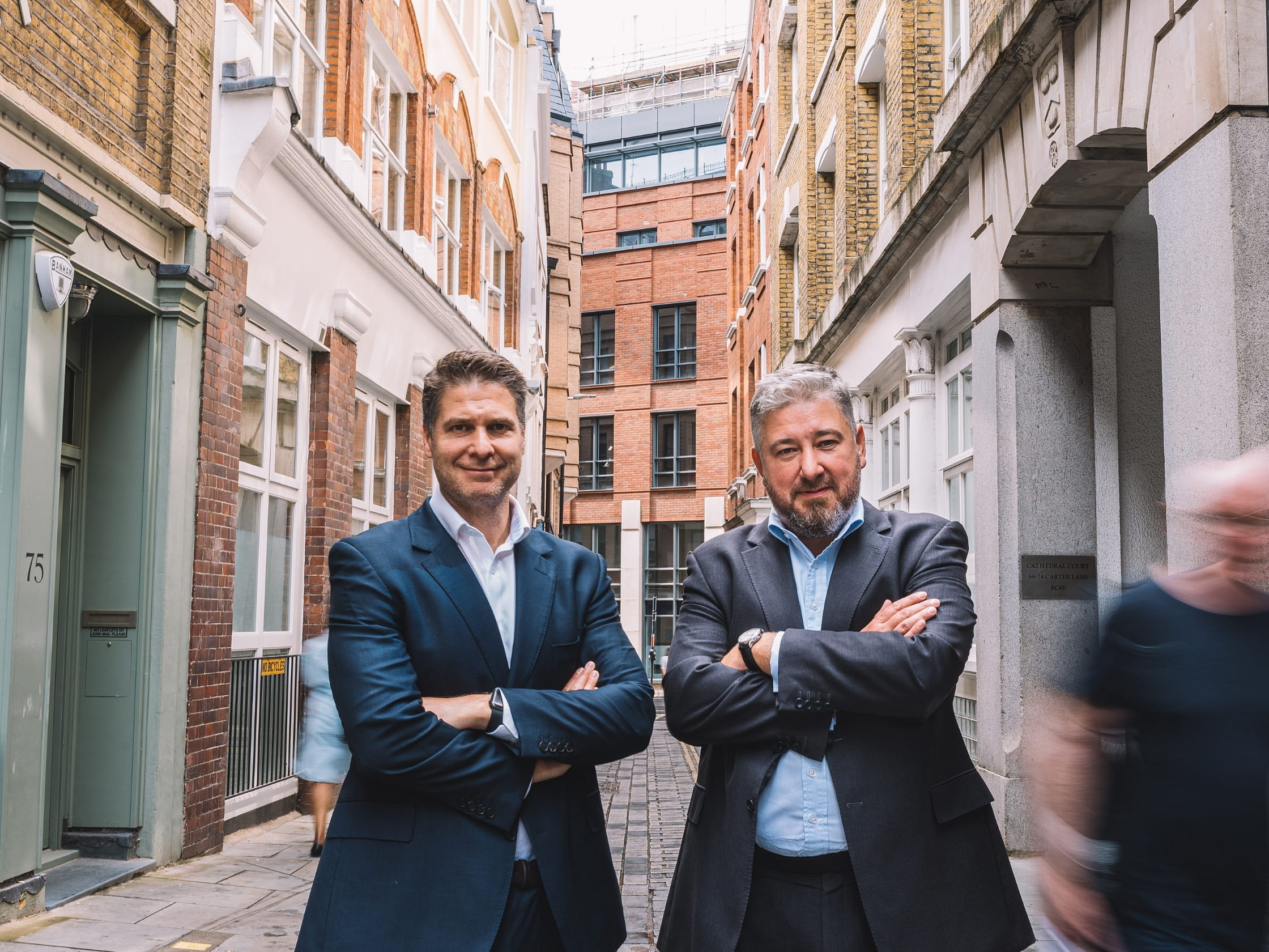 Two people standing in a street.