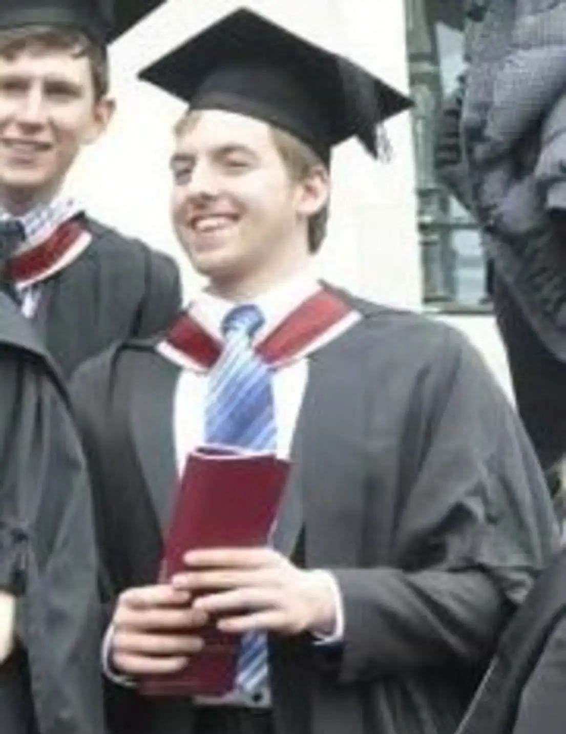 Jon in his gown at a university graduation.