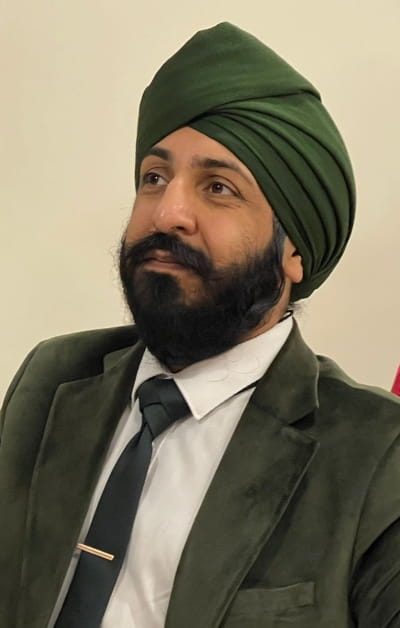 Judge Singh in a suit with a green velvet jacket.