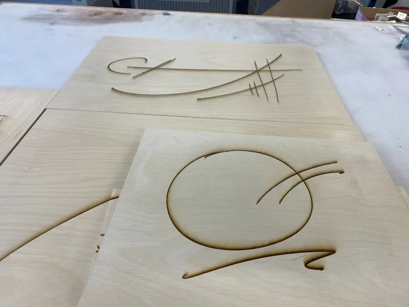 Plywood canvases with abstract line drawings etched into them