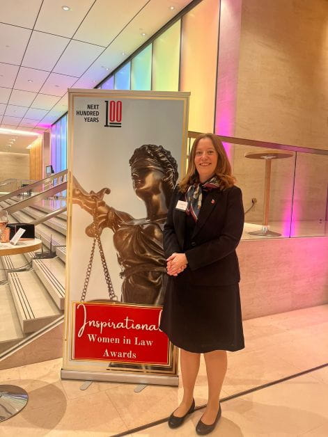 Full length image of a person standing in formal clothes at an event