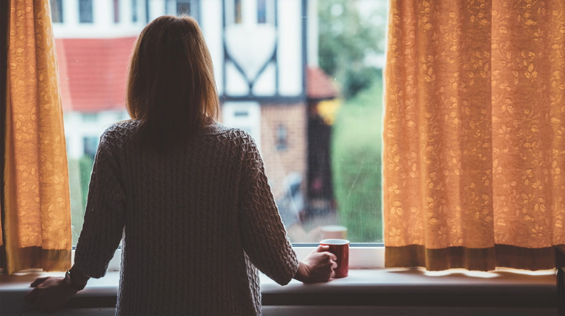 Person at home looking out of the window