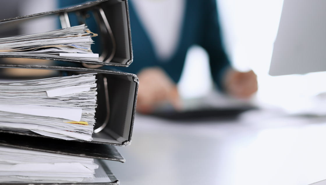 Person working at desk with paperwork