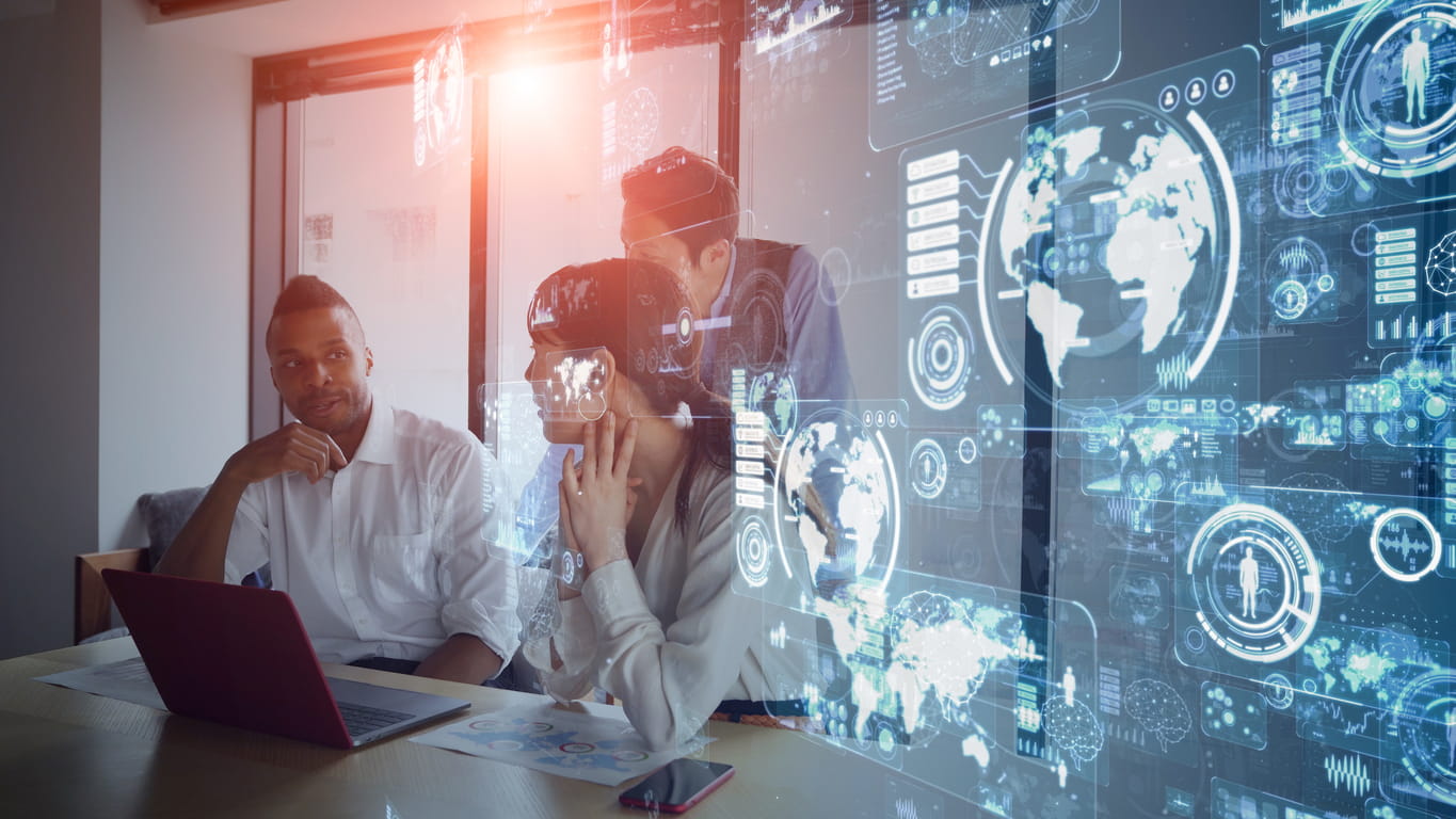 colleagues around a laptop with cybersecurity symbols on the right