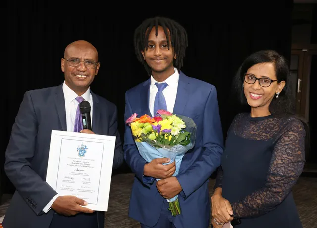 Solicitor Abraham Ghebre-Ghiorghis smiles with his son and wife at an event to celebrate his 37 years working at Brighton and Hove City Council