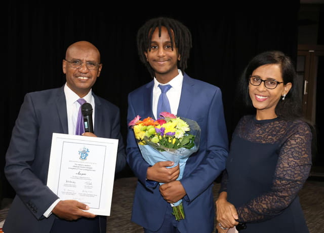 Solicitor Abraham Ghebre-Ghiorghis smiles with his son and wife at an event to celebrate his 37 years working at Brighton and Hove City Council
