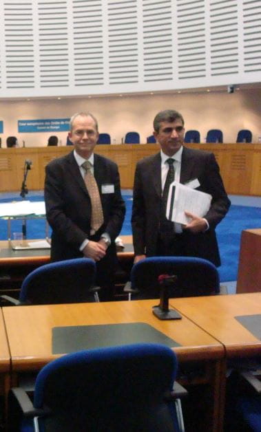 Human rights solicitor Tony Fisher standing with Tahir Elçi inside the Grand Chamber at the European Court in 2007