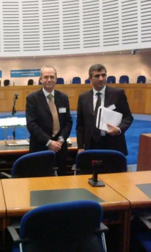 Human rights solicitor Tony Fisher standing with Tahir Elçi inside the Grand Chamber at the European Court in 2007
