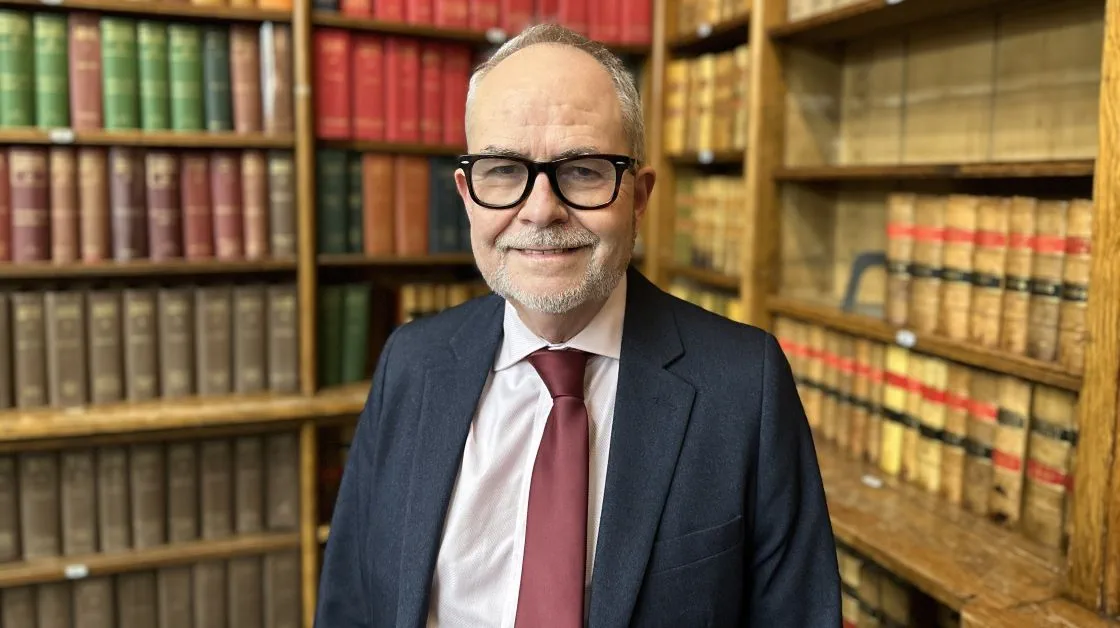 Solicitor Tony Fisher smiling in the Law Society Library