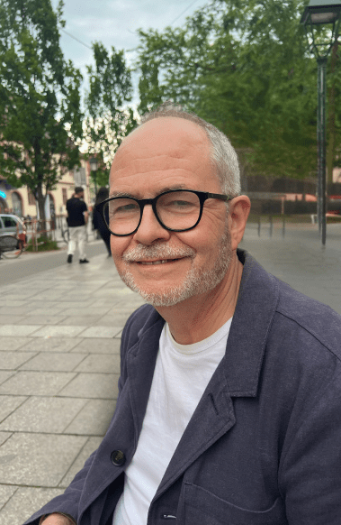 Solicitor Tony Fisher smiling with trees behind him