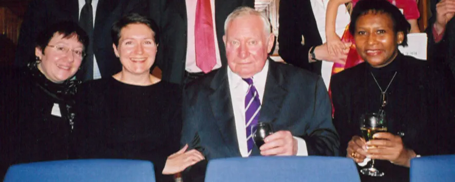 A group of three women and one man smiling at an LPC graduation ceremony. Charlotte Bradbeer and her father are in the centre of the photo and are surrounded by fellow students.