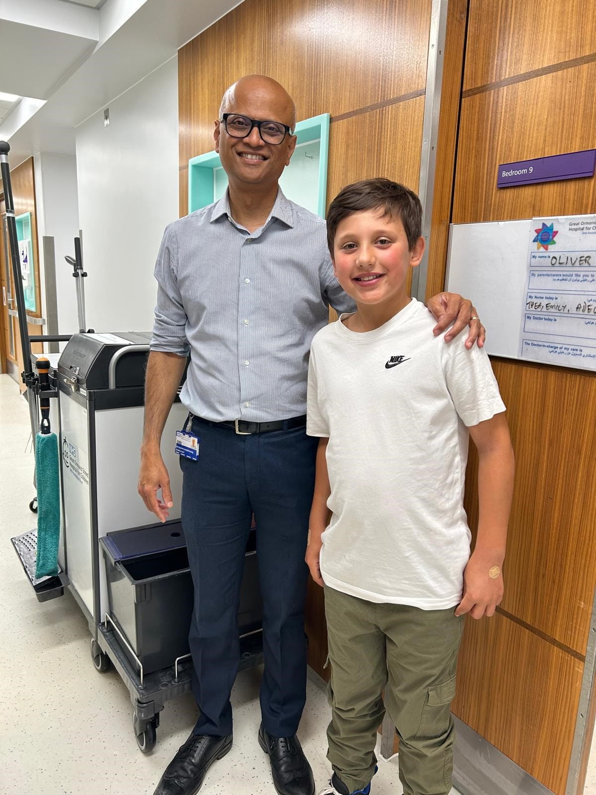 A man and a boy stand in a hospital.