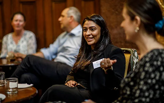An in-house solicitor talks animatedly at a forum.