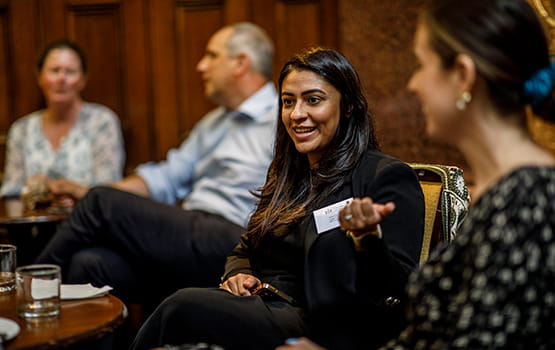 An in-house solicitor talks animatedly at a forum.