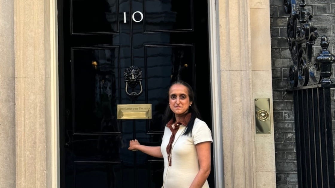 A woman stands outside 10 Downing Street.