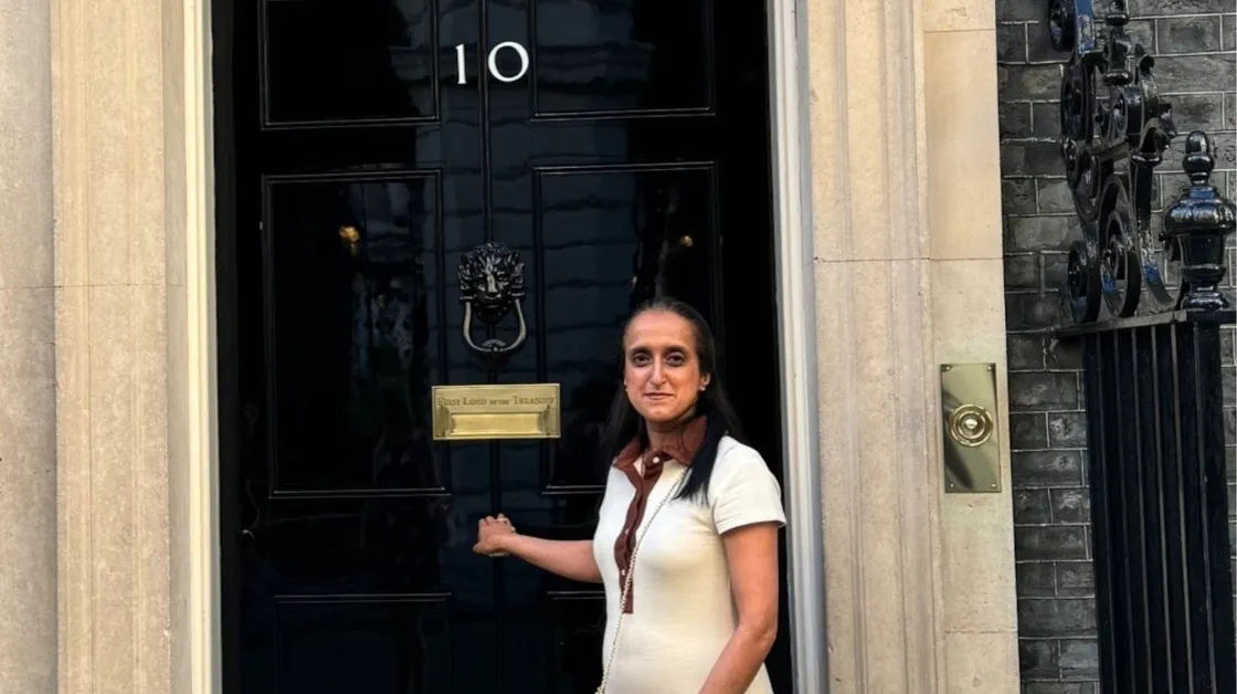 A woman stands outside 10 Downing Street.