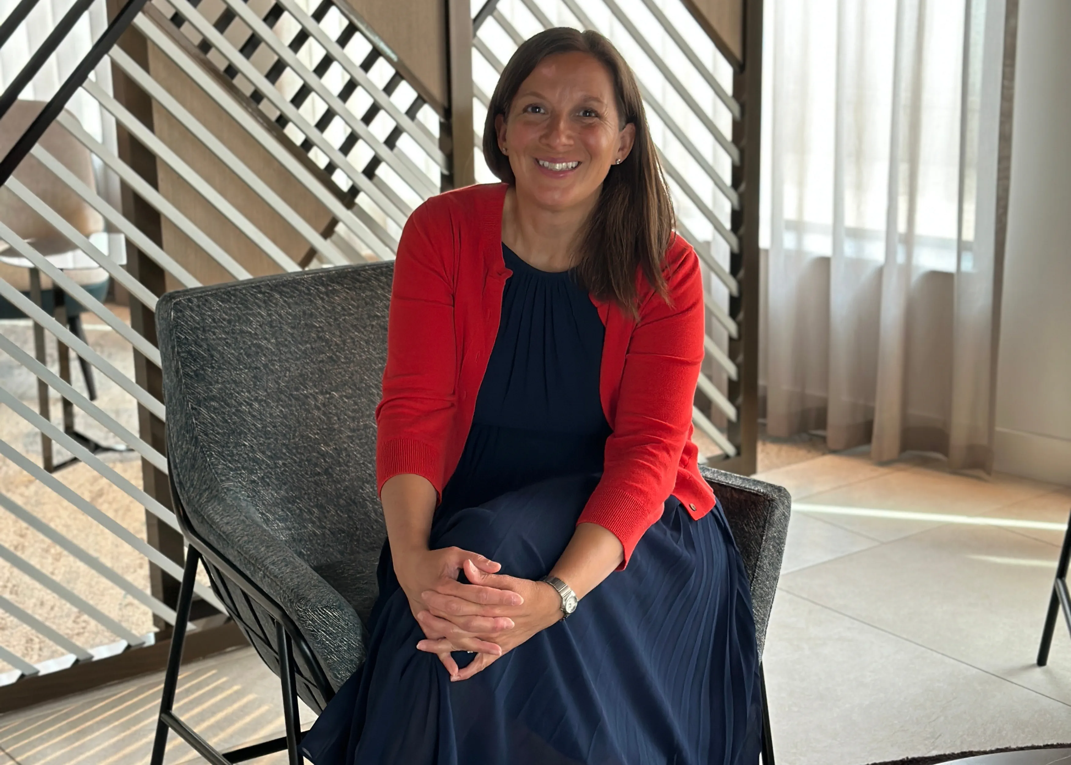 Jessica Clay sits smiling in an office.