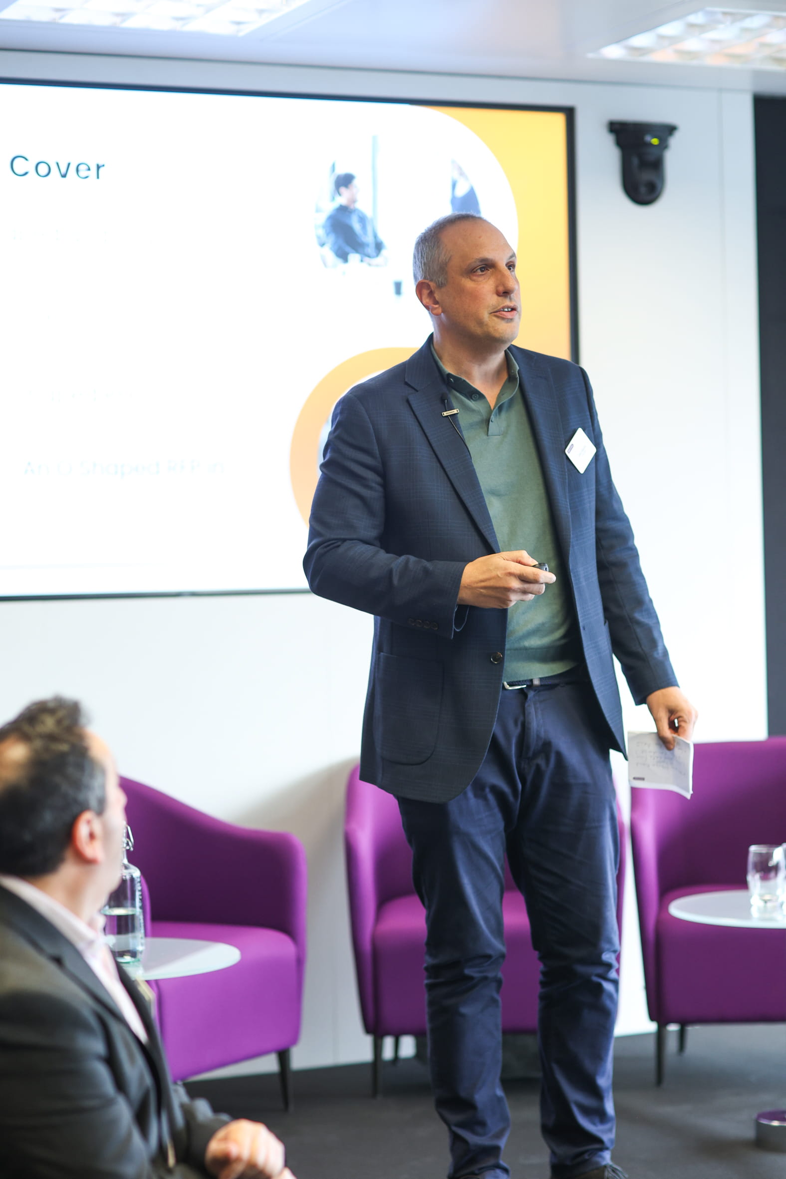 A man walking in front of a presentation.
