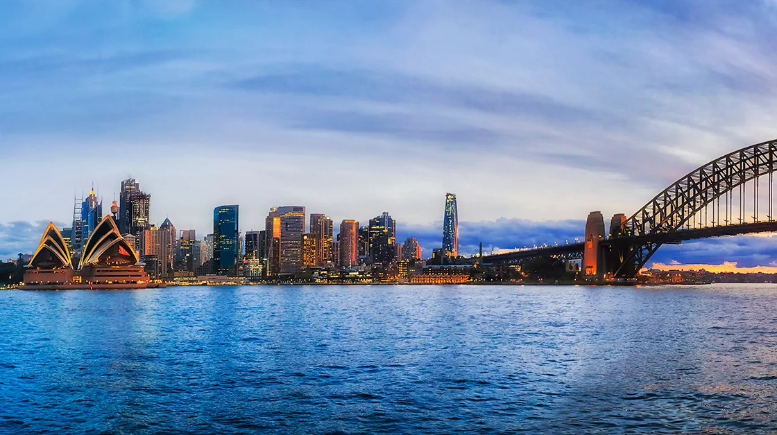 Sydney city waterfront on harbour with bridge arch, opera house and office blocks of the financial district