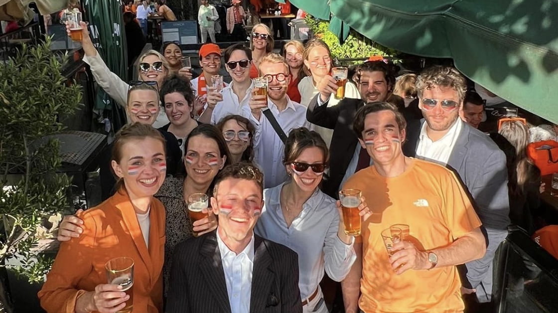 Group of mixed junior solicitors celebrating outside