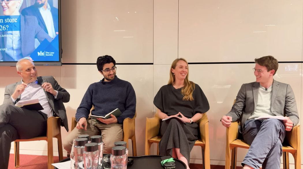 Four solicitors seated in a row at a panel discussion