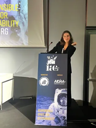 Octavie Ralet stands at a lectern at the International Astronautical Congress 2024 in Milan