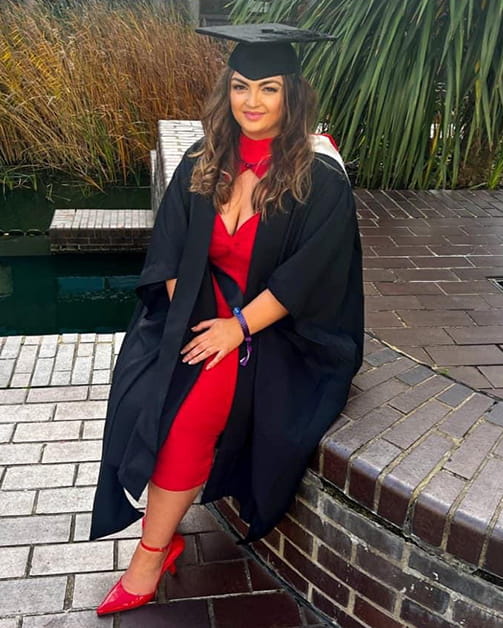 Olivia Rogers wearing graduation robes